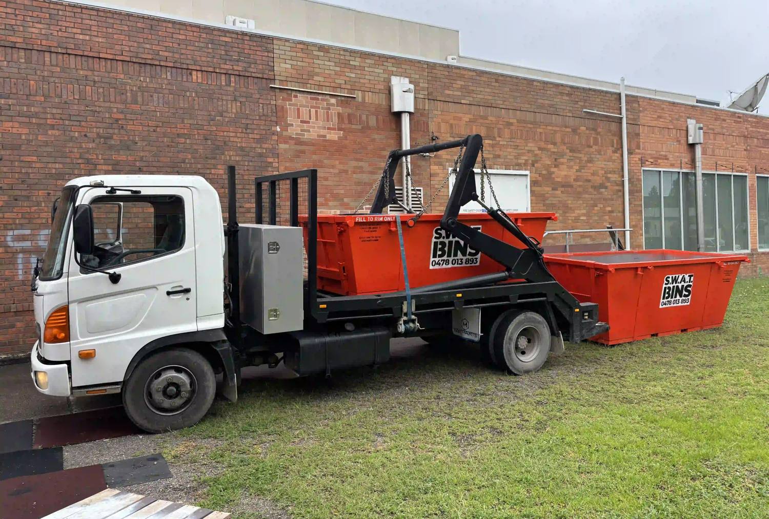The SWAT Bins marrel skip loader truck with a 4 cubic metre skip bin on board and a 6 cubic metre bin behind it